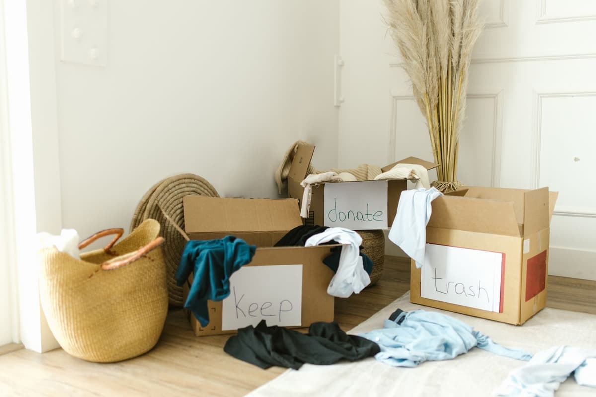Boxes labeled keep, donate, and trash during a property cleanout
